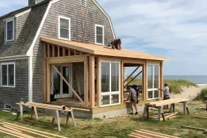 Contractors building a sunroom addition onto a coastal South Shore Massachusetts home.